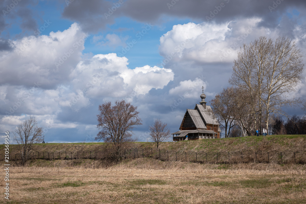 View of the wooden Church of St. Nicholas from the opposite bank of the Kamenka river in Suzdal, Russia View of the wooden Church of St. Nicholas from the opposite bank of the Kamenka river in Suzdal, Russia