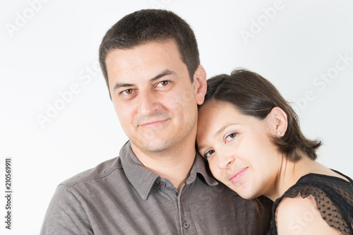 casual cute couple posing in white isolated studio background in love and tenderness