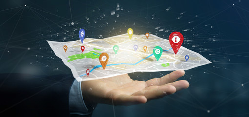 Businessman holding a 3d rendering pin holder on a map