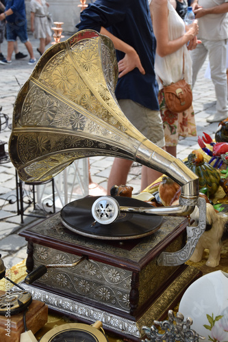 old golden antique gramophone with vinyl record at the market stall