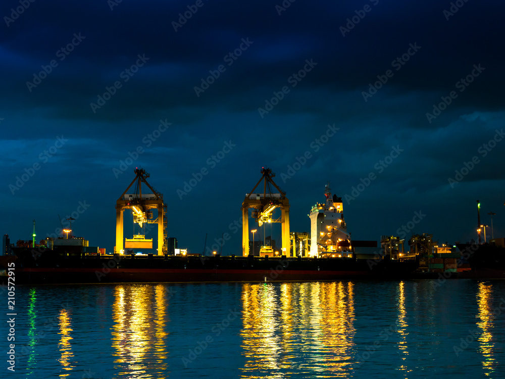 A shipping crane of maritime transportation beside river A shipping crane of maritime transportation beside river