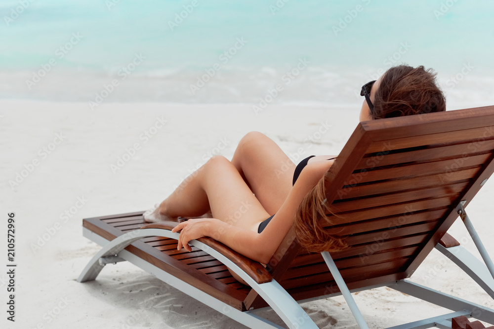 Summer day lifestyle woman relax near luxury  sunbath at the beach resort in the hotel. Concept Summer