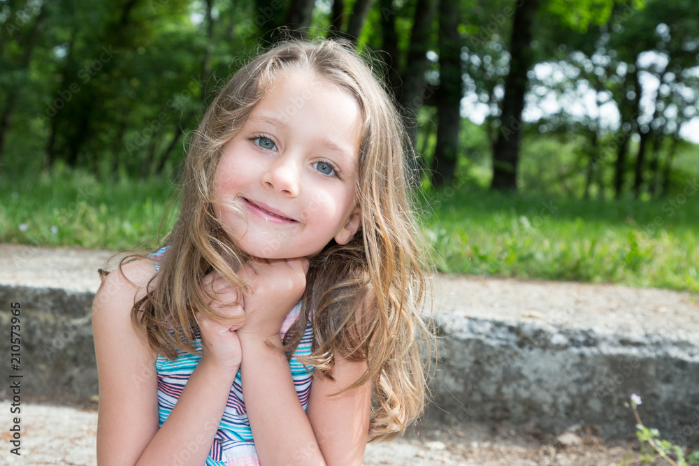 Portrait of happy smiling cute little girl child outdoors in summer day Portrait of happy smiling cute little girl child outdoors in summer day