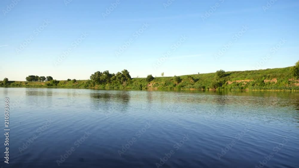 Bright summer nature panorama, forest trees and river with reflection in water, abstract vivid tranquil and relax background Bright summer nature panorama, forest trees and river with reflection in water, abstract vivid tranquil and relax background
