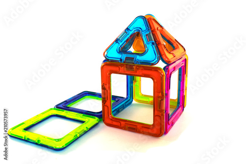Toy house made from a magnetic constructor on a white background