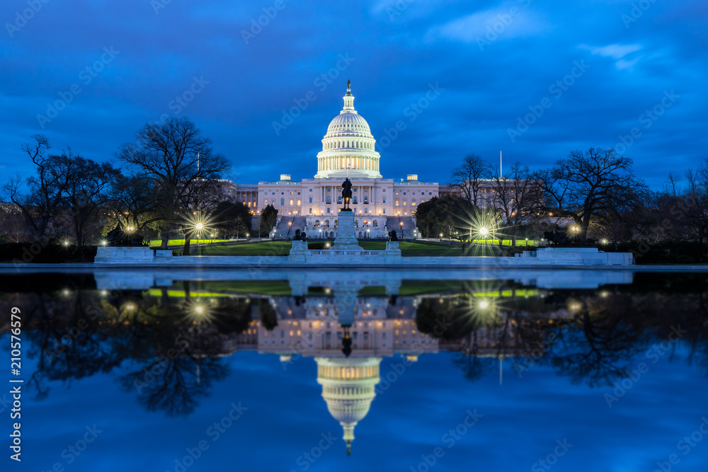 The United States Capitol with reflection at night Washington DC USA