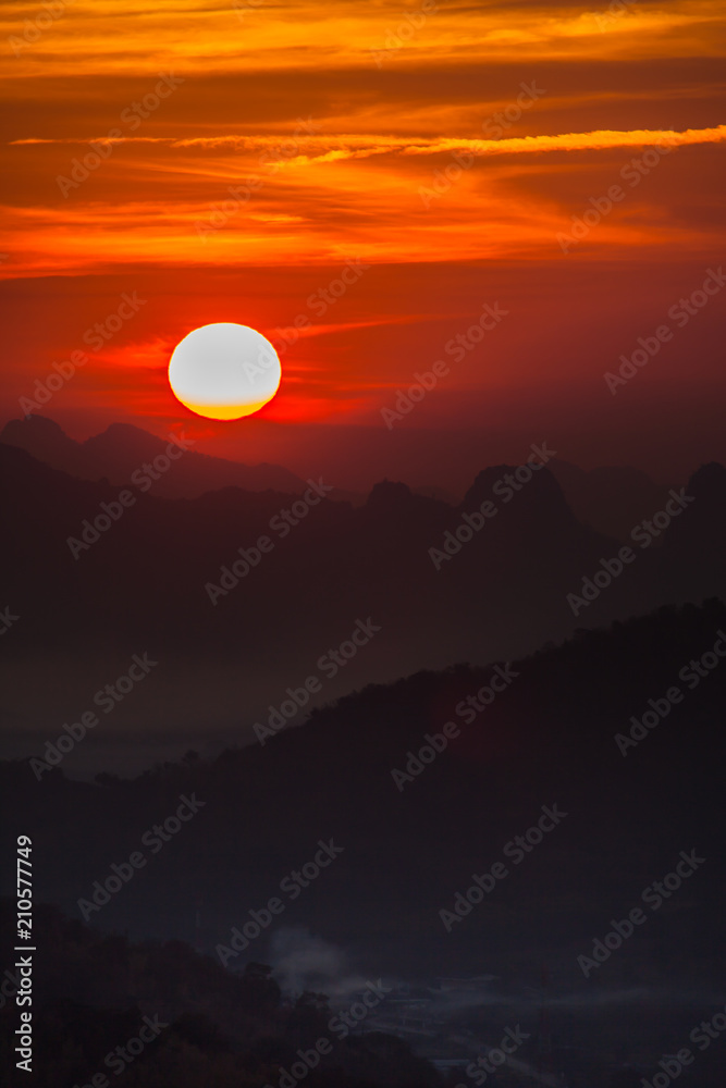 Colorful sky of sunrise above mountain on cloudy at winter season Colorful sky of sunrise above mountain on cloudy at winter season