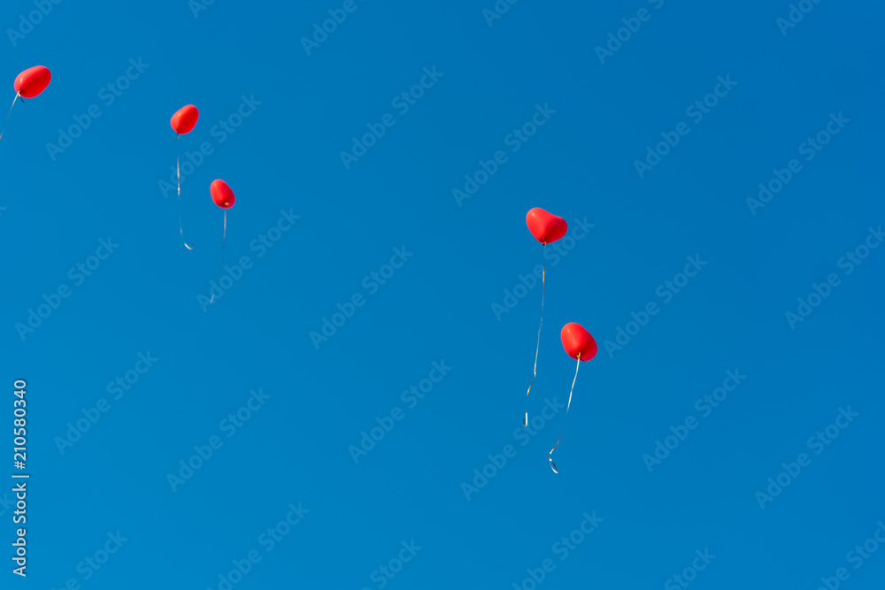 Red ballons with the messages in the blue sky