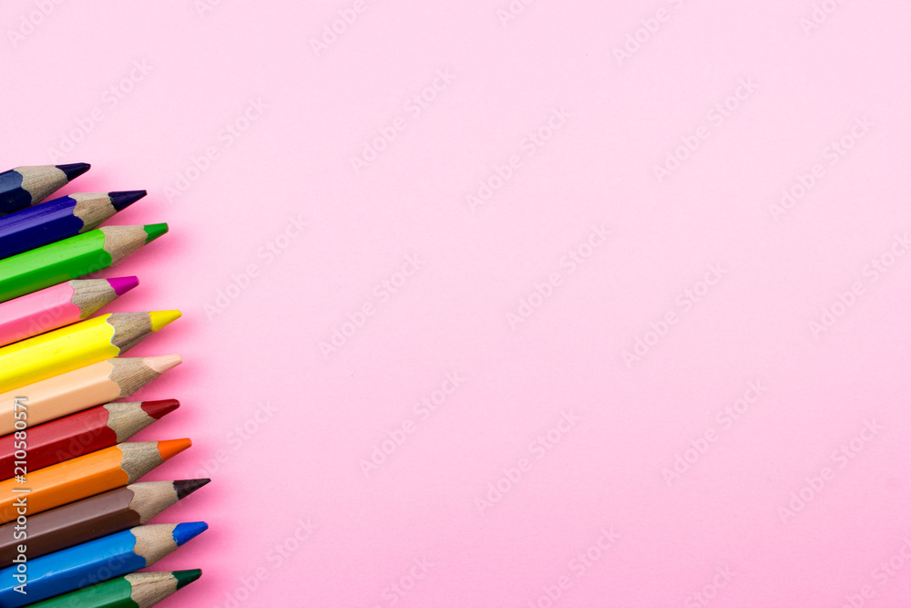 Pencils set on rose tone color paper. Empty space for text and design. Minimalism concept Pencils set on rose tone color paper. Empty space for text and design. Minimalism concept