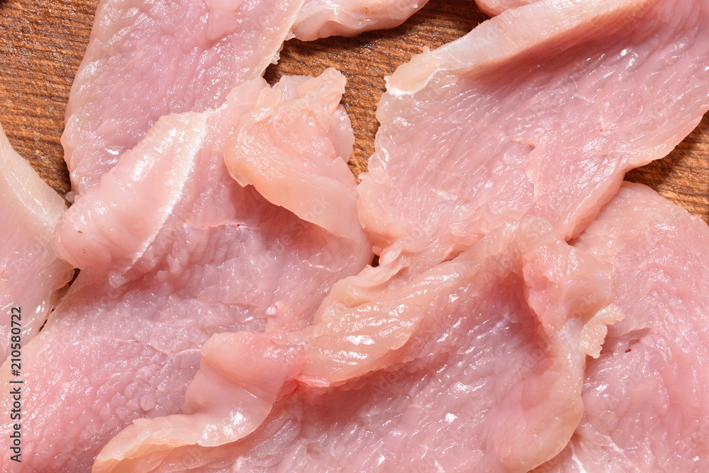 Raw and sliced turkey meat. Fresh pink turkey meat, close-up Raw and sliced turkey meat. Fresh pink turkey meat, close-up