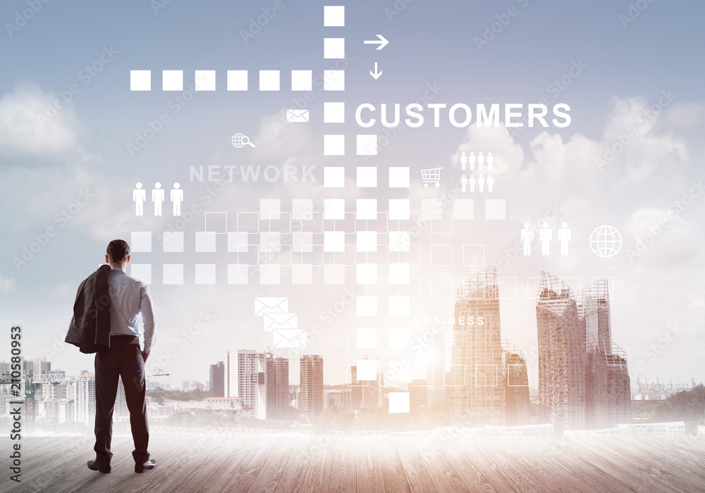 Pensive businessman looking at user interface against modern city background Pensive businessman looking at user interface against modern city background