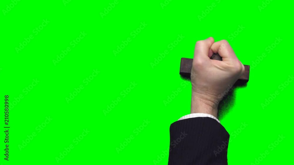 Businessman's hand stamping with a rubber stamp on a chroma key green background