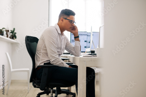 Application developer working on computer in office
