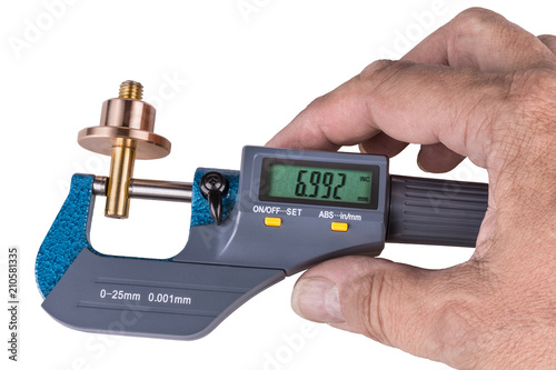 Fotografi Human hand holding a digital micrometer close-up