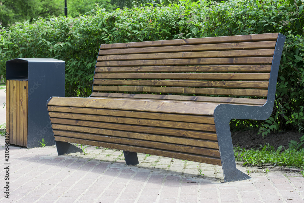 wooden brown bench in the summer green sunny forest park wooden brown bench in the summer green sunny forest park
