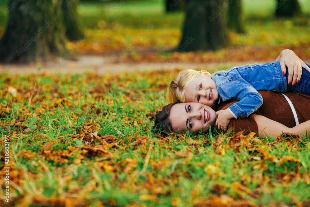 beautiful young mother daughter relaxing sitting grass background summer meadow green grass trees