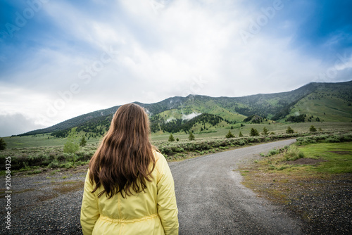 Woman walking or hiking in the mountains long hair 