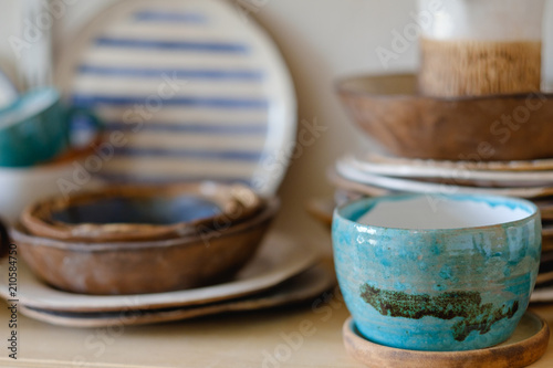 pottery handcraft hobby. assortment of handmade clay plates and jugs photo