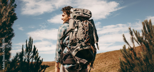 Man with backpack going on a camping photo