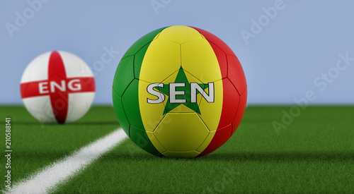 England vs. Senegal Soccer Match - Soccer balls in Englands and Senegals national colors on a soccer field. Copy space on the right side - 3D Rendering 