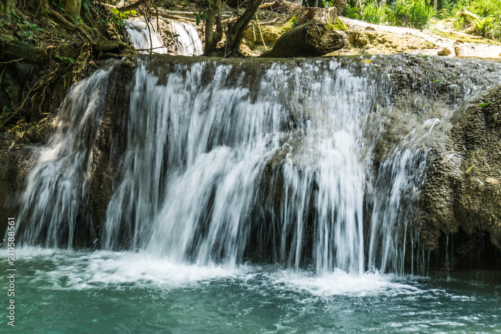 Tad Kwang Si (Xi) the biggest water fall land mark in Luang Prabang, Laos ,beautiful turquoise color water at tropical forest in north Lao, for use as a background or travel advertisement image