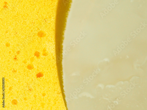 Background from a yellow household sponge. Close up.