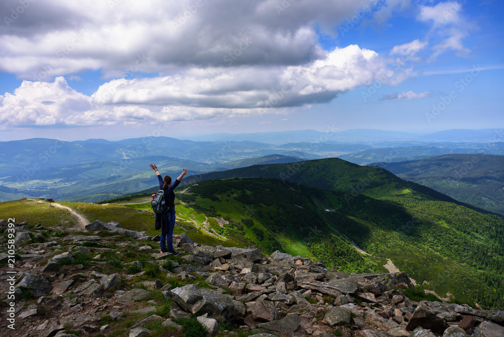 Girl traveler at the top of Tatra mountains