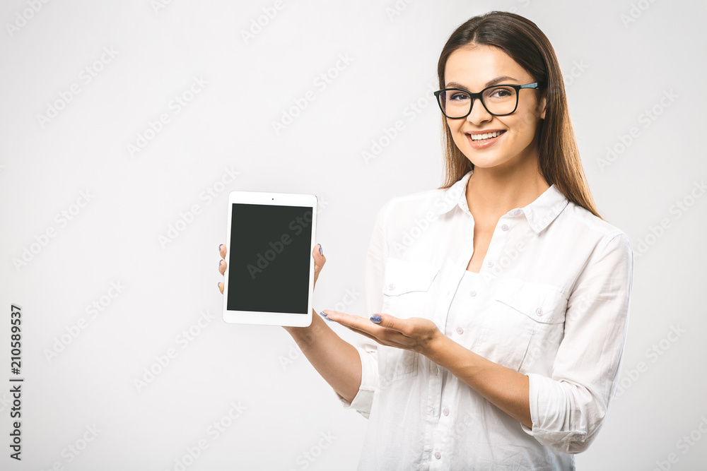 Portrait of a beautiful woman using tablet computer isolated on a white background. Free space for text. Smiling and looking at camera. Portrait of a beautiful woman using tablet computer isolated on a white background. Free space for text. Smiling and looking at camera.