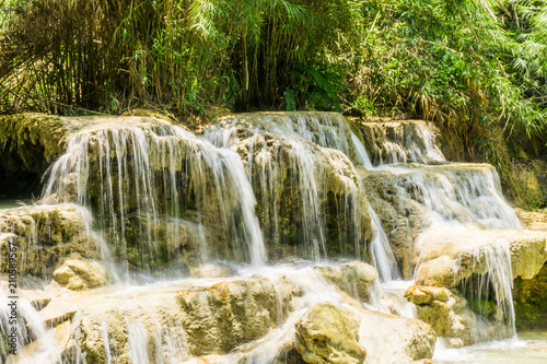 Fototapeta Naklejka Na Ścianę i Meble -  Tad Kwang Si (Xi) the biggest water fall land mark in Luang Prabang, Laos ,beautiful turquoise color water at tropical forest in north Lao, for use as a background or travel advertisement image