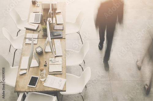 Business man passing by table photo