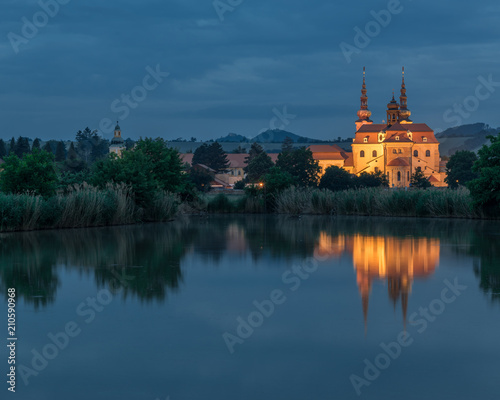 Beautiful pilgrimage church in Velehrad, Czech Republic, photographed during a night photography. Symetrical night photography of a church reflected in a pond