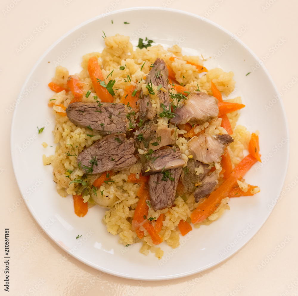 Rice with meat and vegetables view from above, close-up Rice with meat and vegetables view from above, close-up