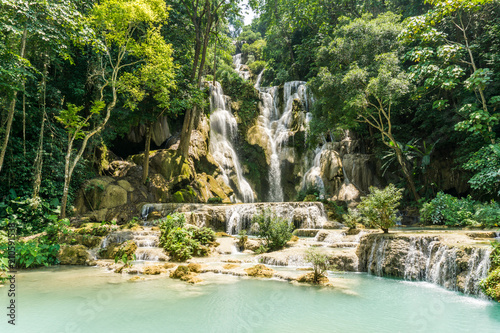 Tad Kwang Si (Xi) the biggest water fall land mark in Luang Prabang, Laos ,beautiful turquoise color water at tropical forest in north Lao, for use as a background or travel advertisement image