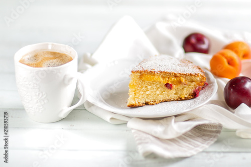 Homemade cake.Food preparation.fruit sweet cake with apricots and plums. Served table With coffee and cake. Kitchen items