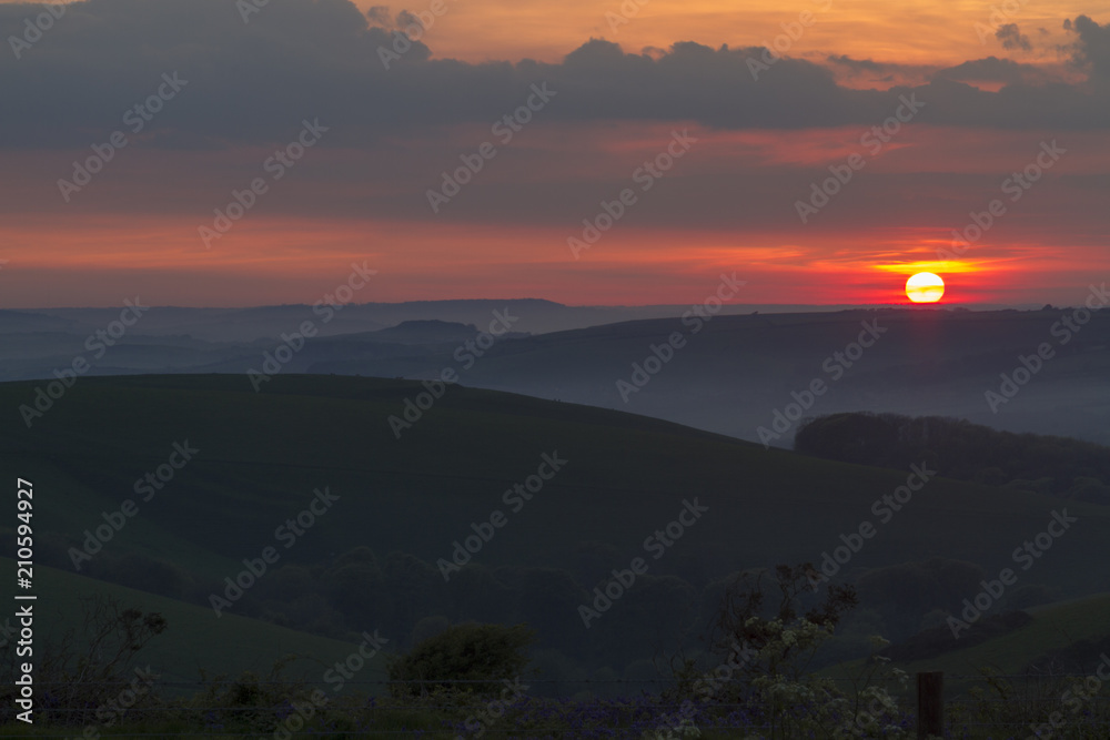 Sunset over rolling hills