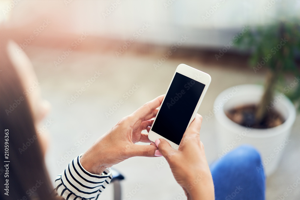 Close-up of woman using smartphone at home Close-up of woman using smartphone at home