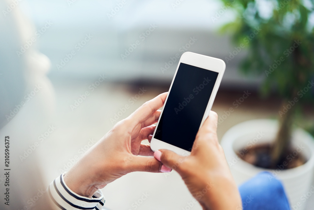 Closeup of smartphone held by young woman at home. Closeup of smartphone held by young woman at home.