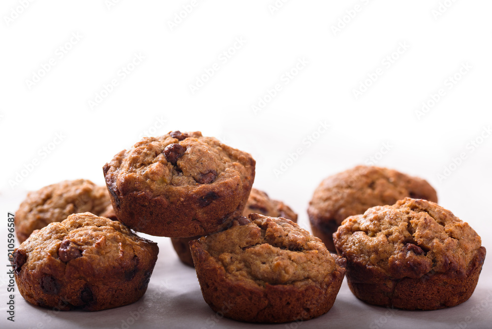 Homemade Banana Muffins with chocolate chips isolated on a white background Homemade Banana Muffins with chocolate chips isolated on a white background