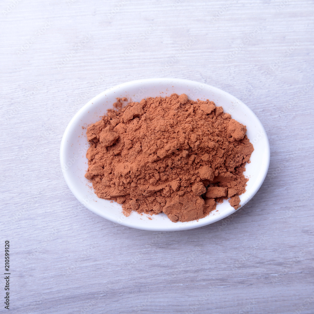 Cocoa powder in bowl. ingredient for homemade tiramisu cake in close up. Cocoa powder in bowl. ingredient for homemade tiramisu cake in close up.