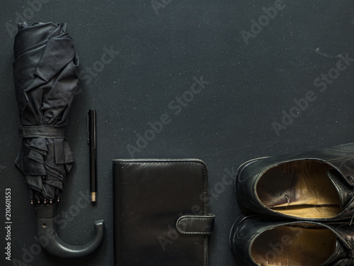 male elegant trendy businessman supplies umbrella shoes notebook and pen copy space