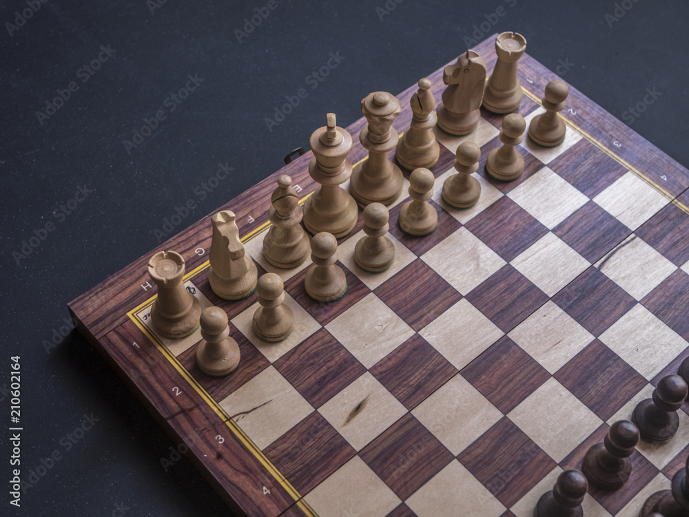 close up default position chess board game on black table close up default position chess board game on black table