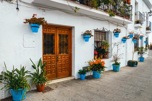 decorated facade of house with flowers in blue pots in Mijas, Spain Fototapet