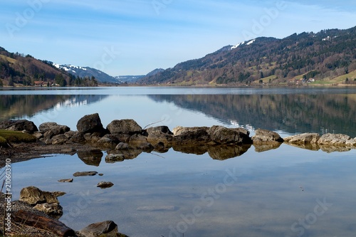Reflection on Alps lake in a clear spring day