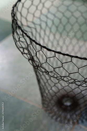 wire basket on marble floor close up