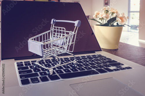 Trolley on a laptop keyboard., Shopping online and business e-commerce concept
