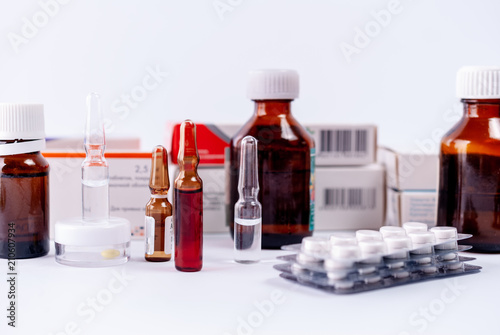 Ampoules, pills, packs with medicine remedy, vitamins on a white background