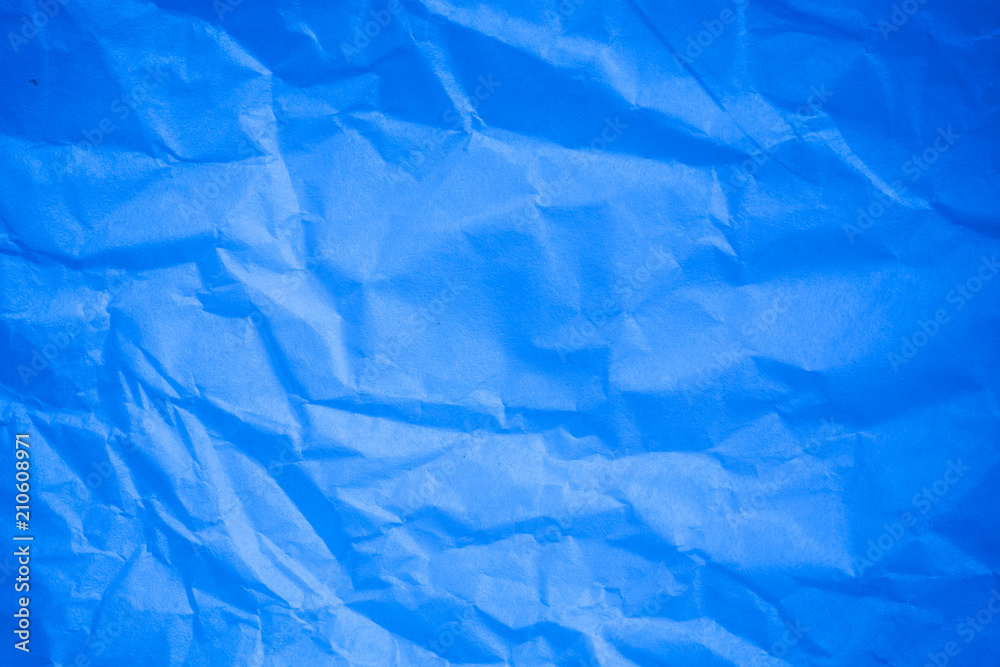Obraz premium Crumpled blue paper background.