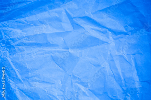 Crumpled blue paper background.