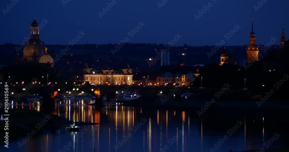 Night skyline in Dresden, with view over the historic buildings and their towers, Carola Bridge and ferry on Elbe River (Saxony, Germany) Night skyline in Dresden, with view over the historic buildings and their towers, Carola Bridge and ferry on Elbe River (Saxony, Germany)