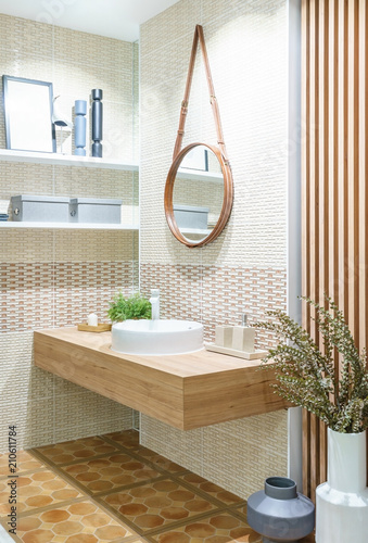 Modern wooden bathroom with mirror, toilet, cabinet and sink